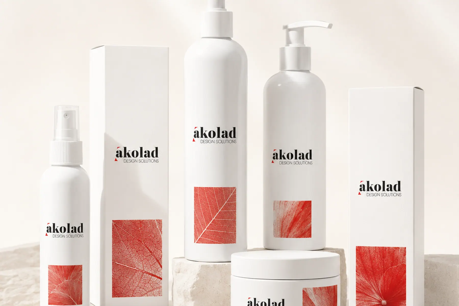 A range of white cosmetic bottles, jars and cartons with red botanical imagery, arranged on stone plinths.